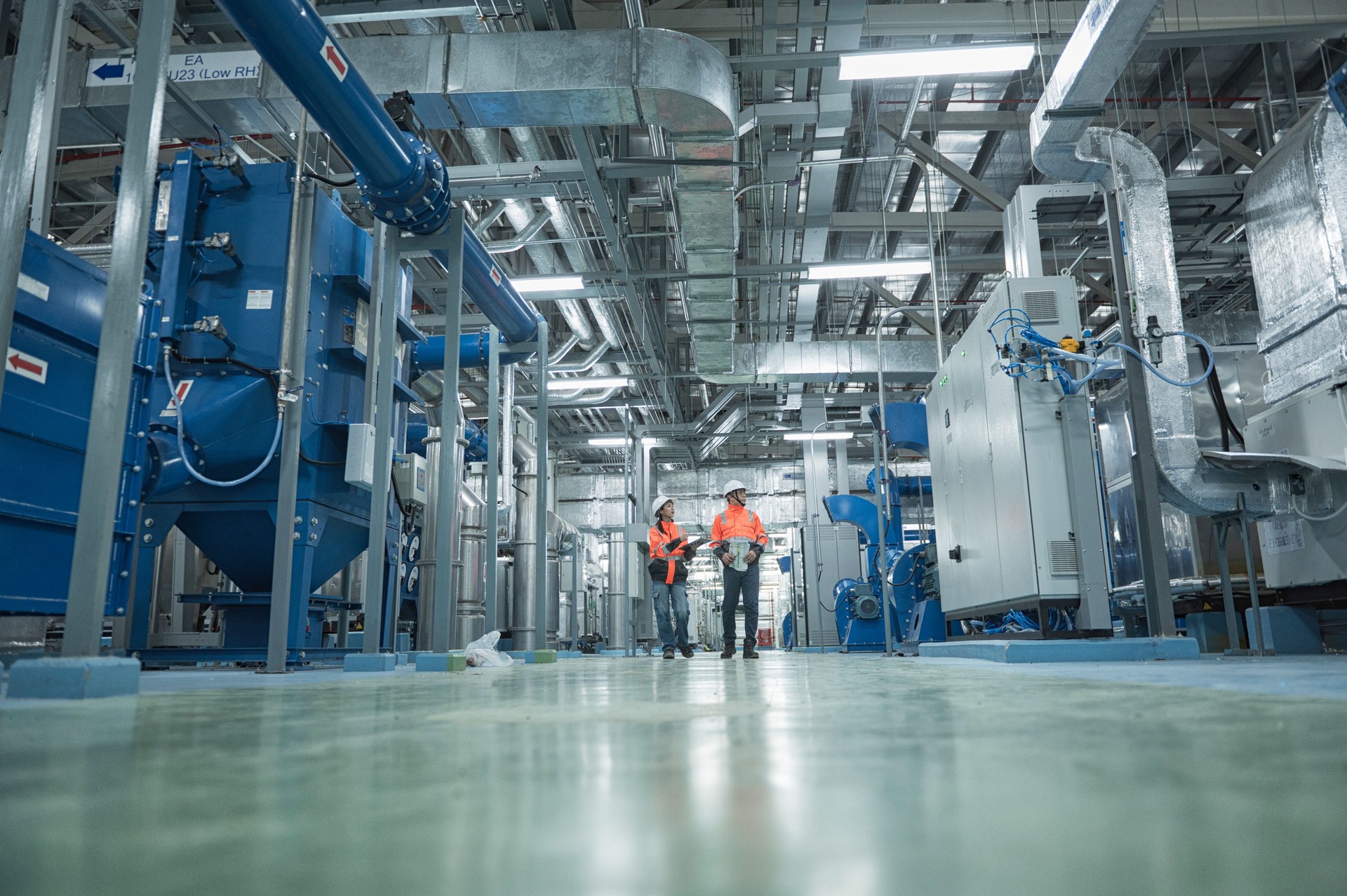 Male and Female engineer on industry  plant.  Engineers Inspecting Modern Industrial Facility