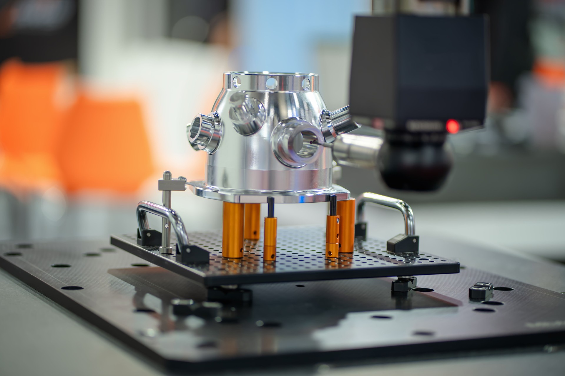 A Coordinate Measuring Machine (CMM) for precision measurement in an industrial setting, focusing on accuracy of surface and scale of autometed metal parts.